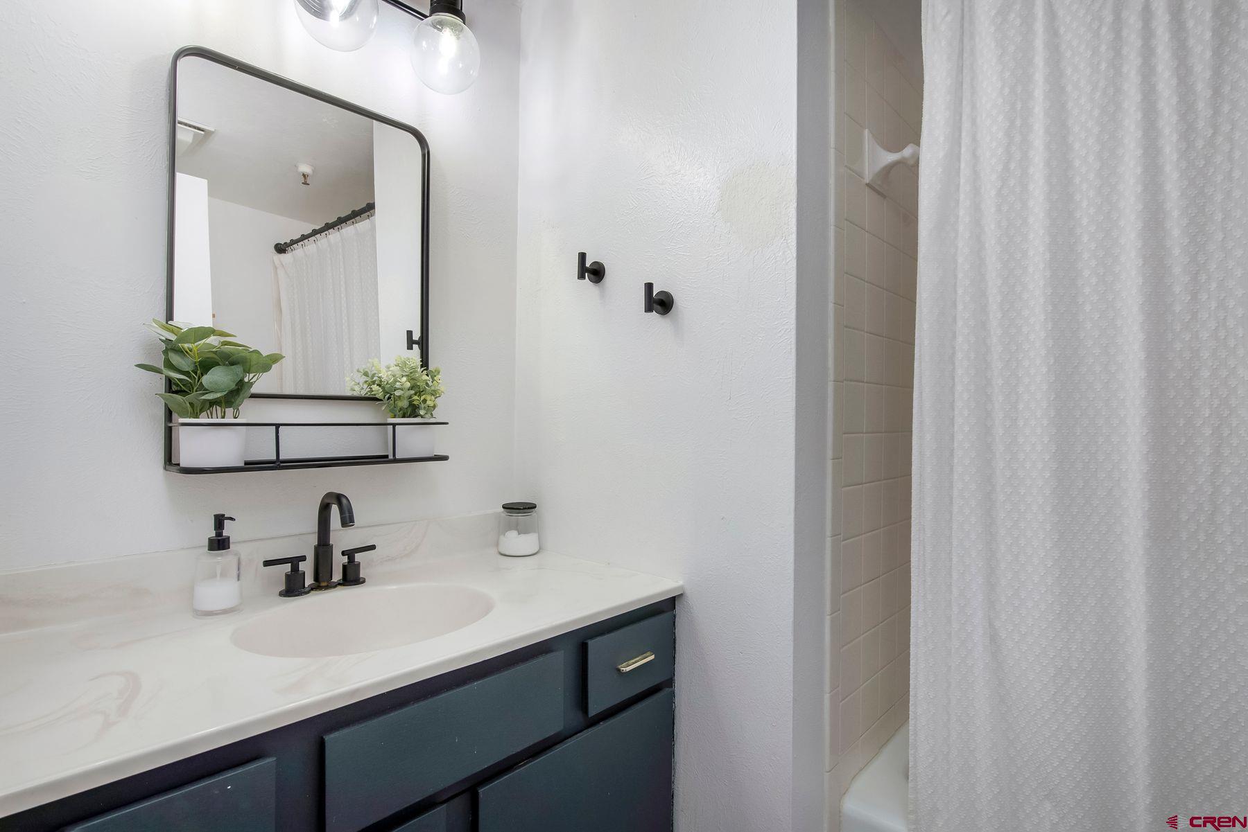 32 Hunter Hill Road, Unit B204 Crested Butte, CO 81225 - Photo 19 of 33 a bathroom with a sink and a mirror
