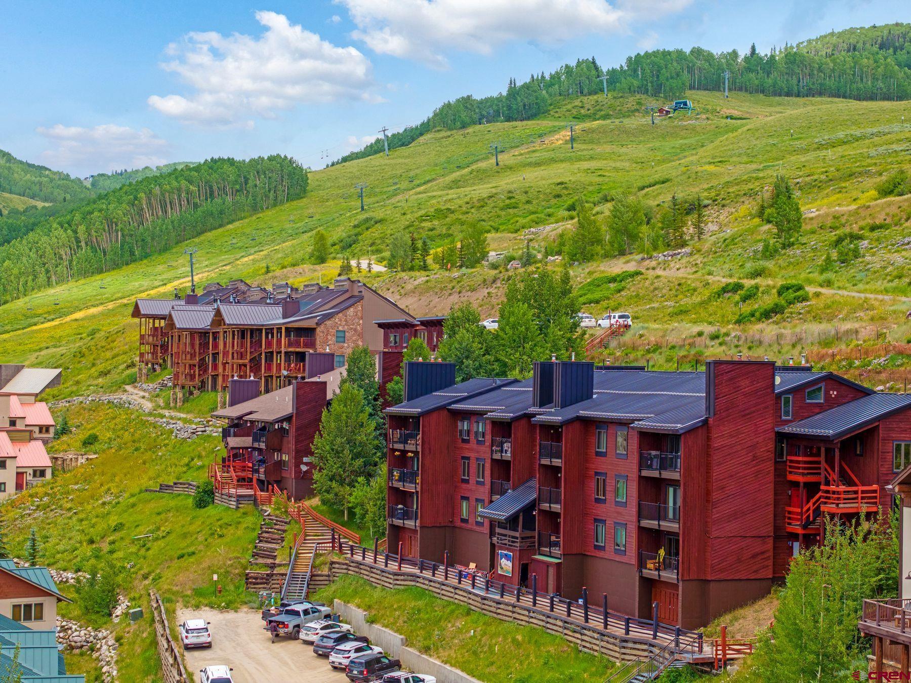 32 Hunter Hill Road, Unit B204 Crested Butte, CO 81225 - Photo 28 of 33 a view of a big house with a big yard and large trees