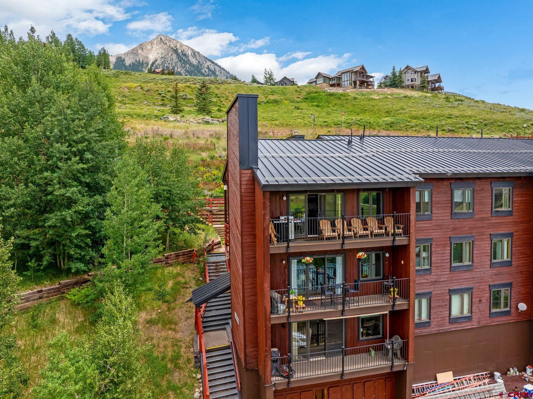 32 Hunter Hill Road, Unit B204 Crested Butte, CO 81225 - Photo 3 of 33 a front view of a house with a yard