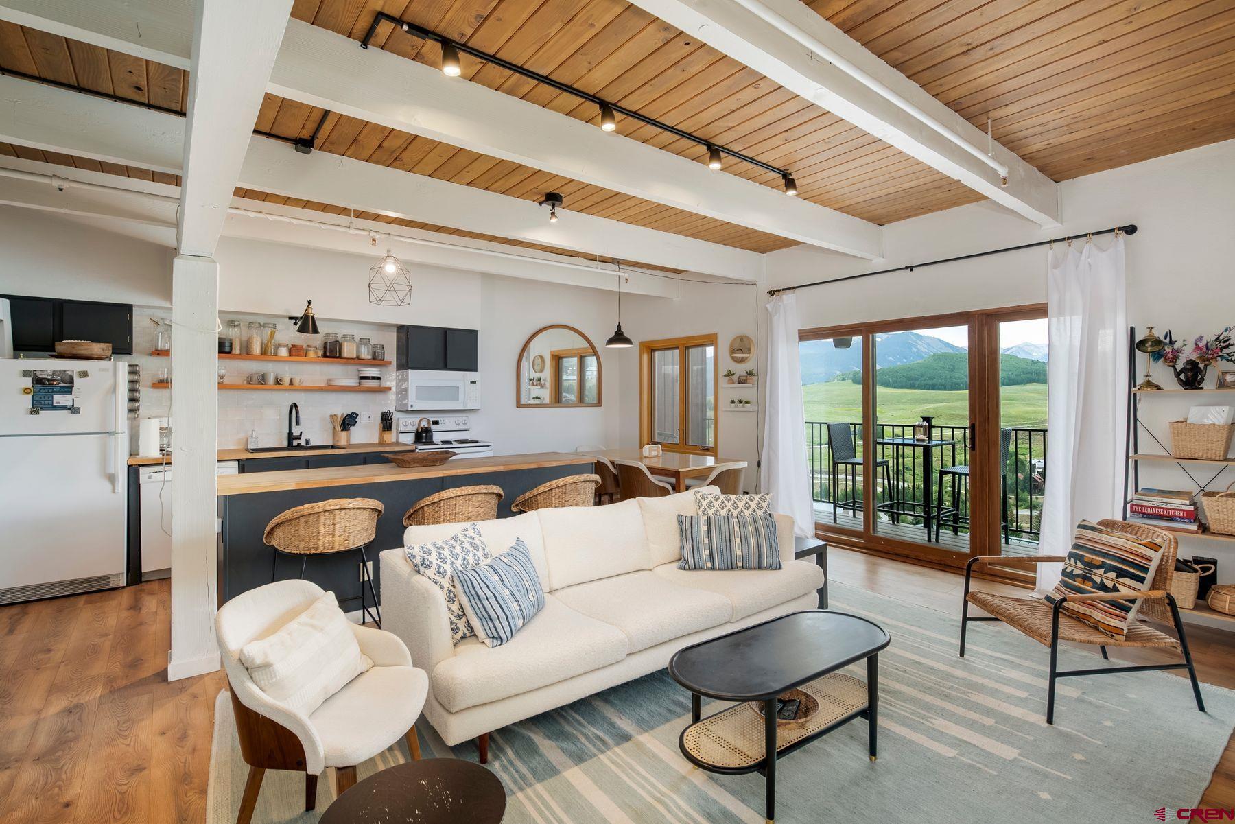 32 Hunter Hill Road, Unit B204 Crested Butte, CO 81225 - Photo 4 of 33 a living room with furniture and a large window