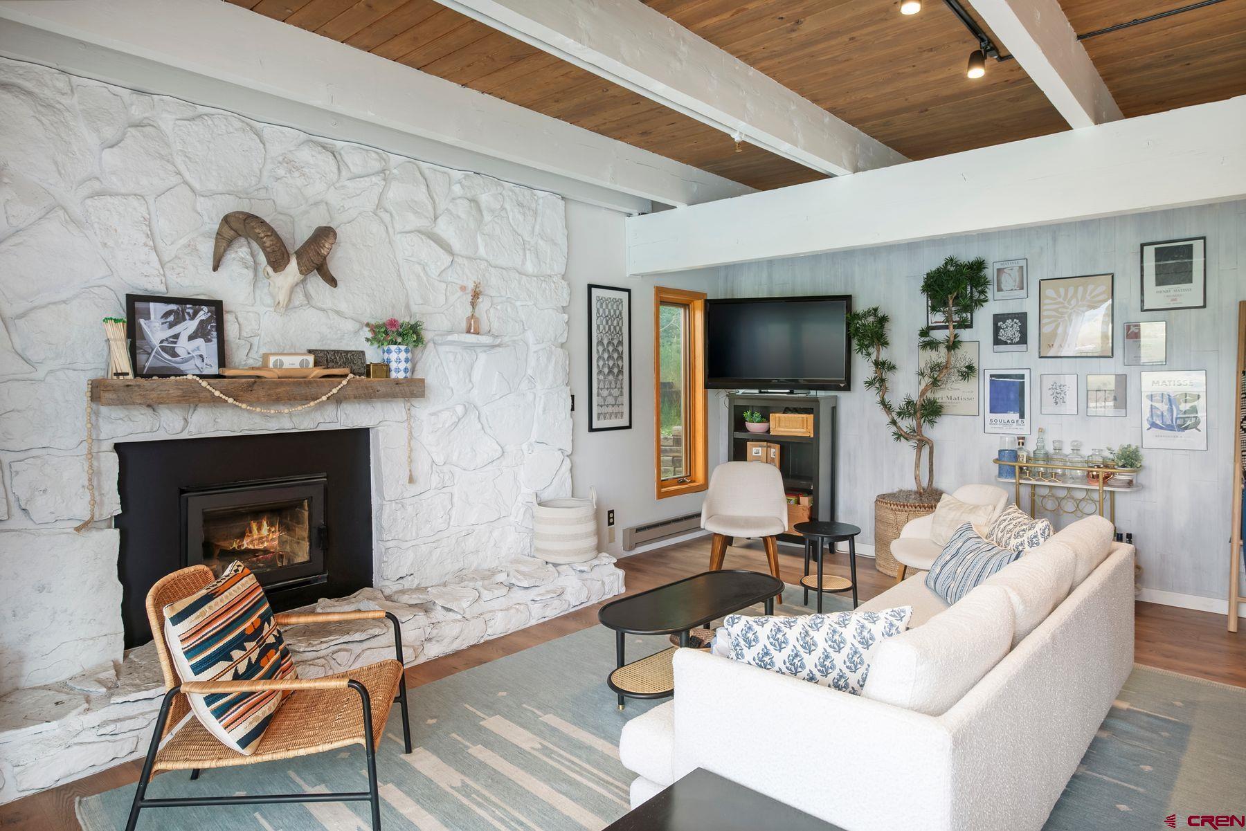 32 Hunter Hill Road, Unit B204 Crested Butte, CO 81225 - Photo 6 of 33 a living room with furniture and a fireplace