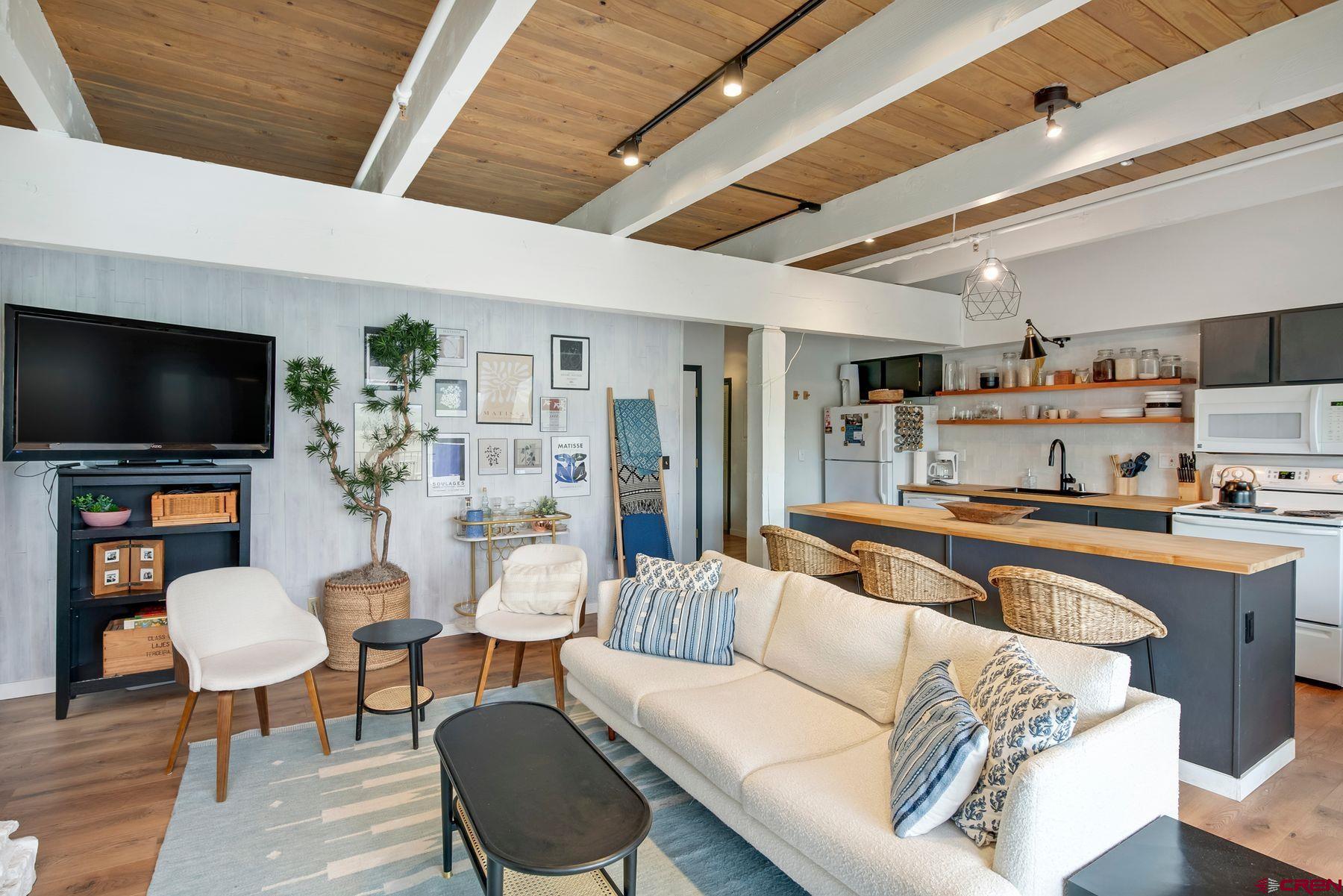 32 Hunter Hill Road, Unit B204 Crested Butte, CO 81225 - Photo 7 of 33 a living room with furniture and a flat screen tv