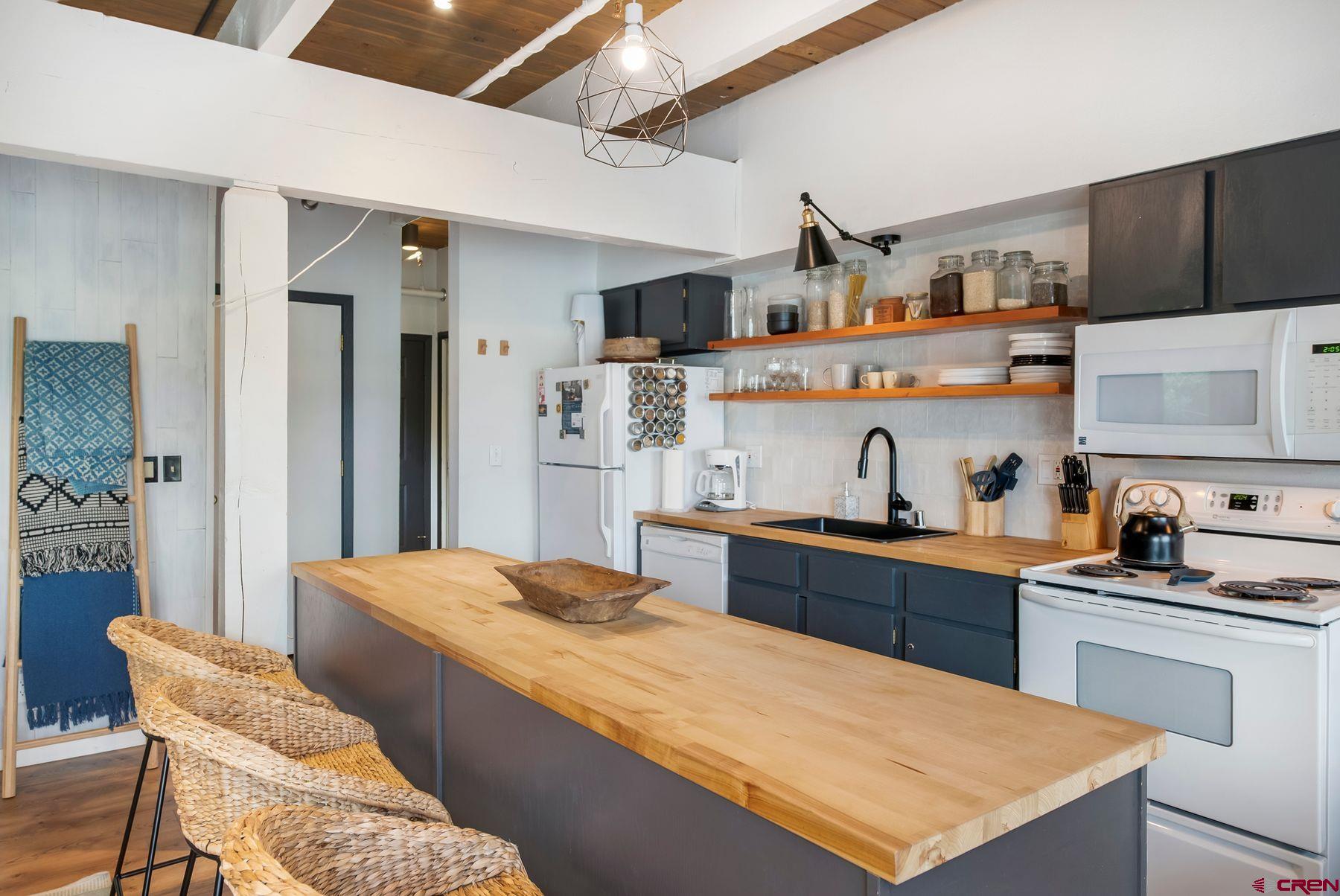 32 Hunter Hill Road, Unit B204 Crested Butte, CO 81225 - Photo 8 of 33 a large kitchen with sink and refrigerator