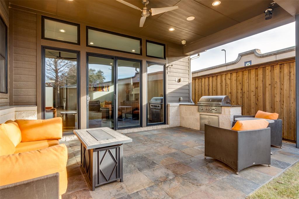 7912 Hanover Street Dallas, TX 75225 - Photo 5 of 29 Covered patio featuring slate tile flooring and a built-in outdoor kitchen with a stainless steel grill