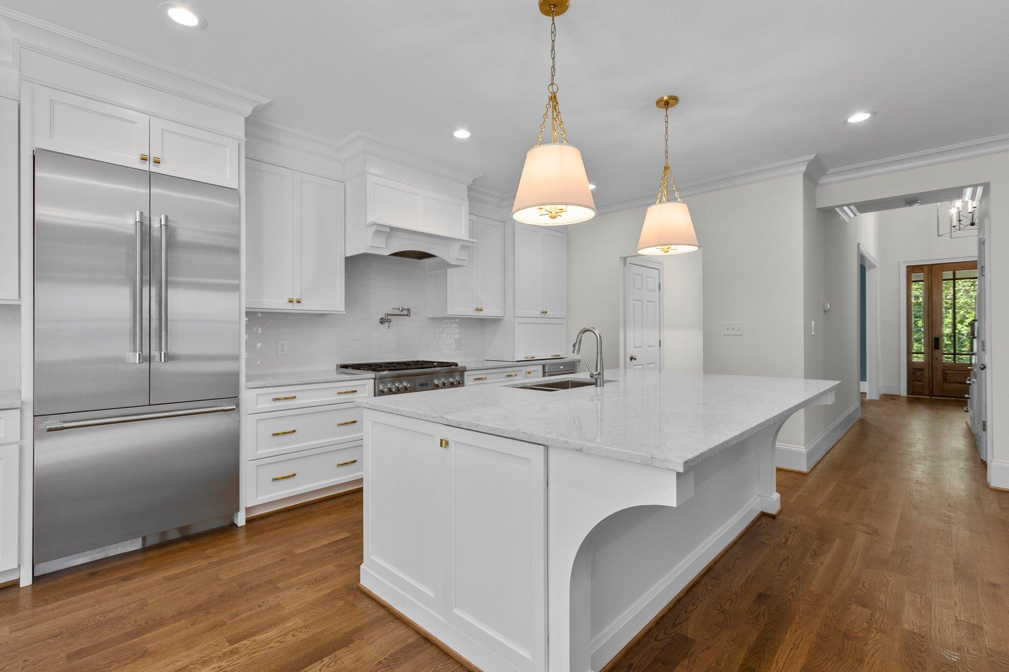 1500 Banbury Road Raleigh, NC 27607 - Photo 10 of 39 Pull up a chair to this extra large island with quartzite countertop and beautiful golden pendant lighting. Kitchen