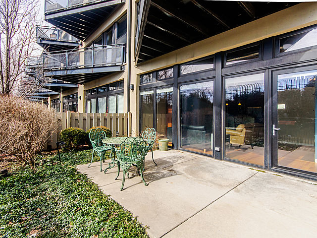 1111 West 15th Street, Unit 111 Chicago, IL 60608 - Photo 14 of 17 a view of a patio with table and chairs and potted plants