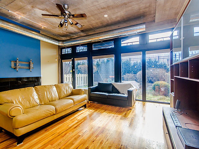 1111 West 15th Street, Unit 111 Chicago, IL 60608 - Photo 5 of 17 a living room with furniture and a large window