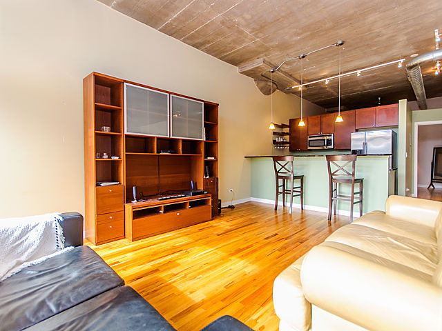 1111 West 15th Street, Unit 111 Chicago, IL 60608 - Photo 8 of 17 a bed room with a bed and a television