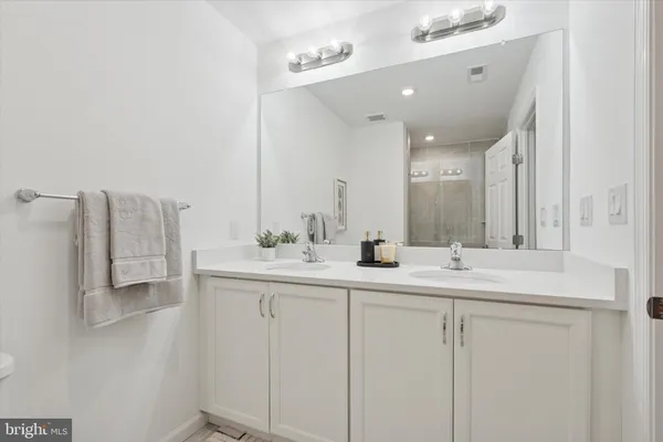 a bathroom with double sink and mirror