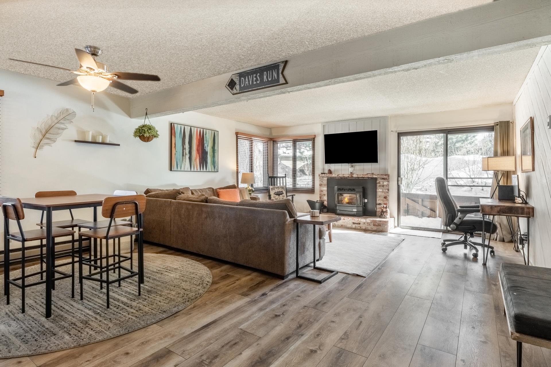 2 Arrowhead Drive, Unit 27 Mammoth Lakes, CA 93546 - Photo 5 of 26 a living room with furniture a fireplace and a flat screen tv