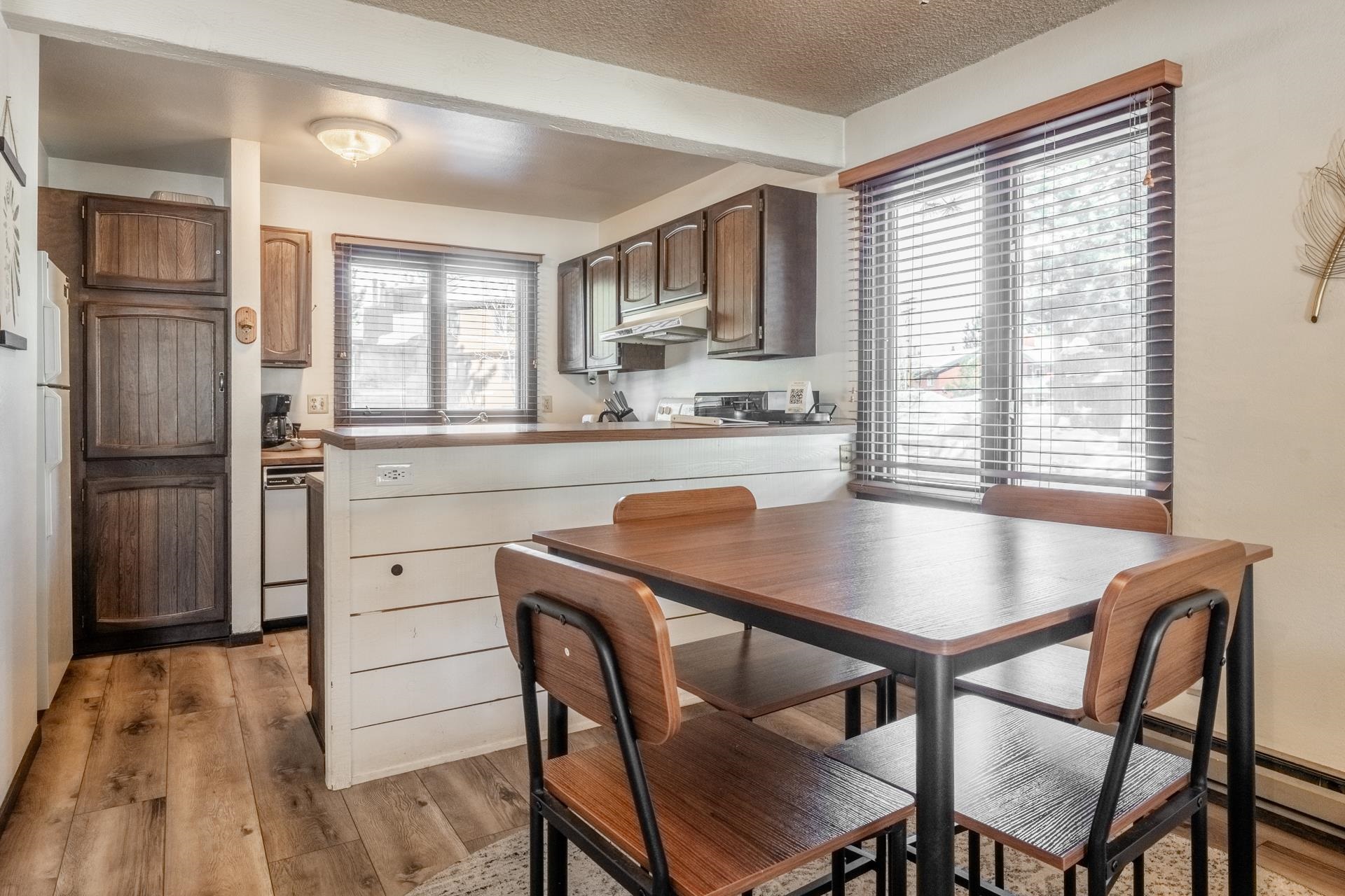 2 Arrowhead Drive, Unit 27 Mammoth Lakes, CA 93546 - Photo 9 of 26 a kitchen with a table chairs refrigerator and cabinets