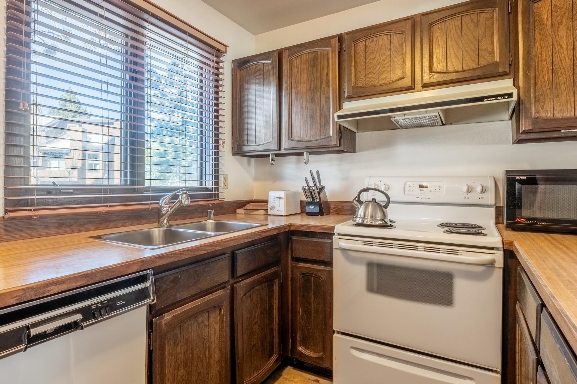 2 Arrowhead Drive, Unit 27 Mammoth Lakes, CA 93546 - Photo 10 of 26 a kitchen with stainless steel appliances granite countertop a sink and cabinets