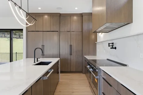 a kitchen with a sink and wooden cabinets