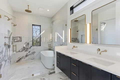 a spacious bathroom with a double vanity sink mirror and double
