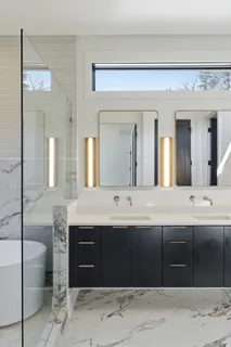 a spacious bathroom with a double vanity sink and a mirror