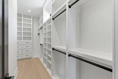 a view of walk in closet with empty racks