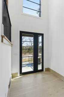 a view of an empty room with window and fire place