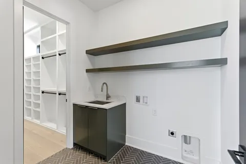 a kitchen with a sink and a refrigerator