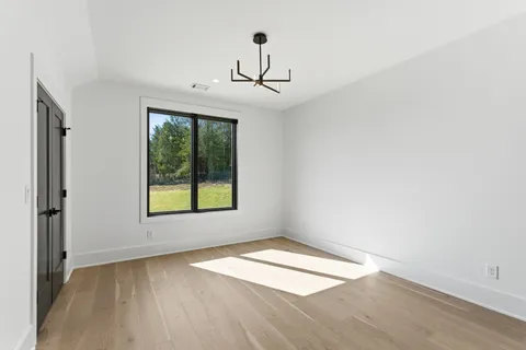 a bathroom with a sink and mirror with toilet