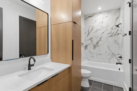 a view of a room with wooden floor and white walls