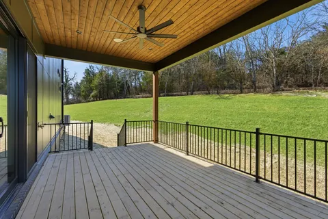 a view of a deck with a big yard