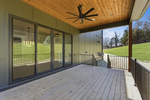 a view of a porch with wooden floor and iron stairs