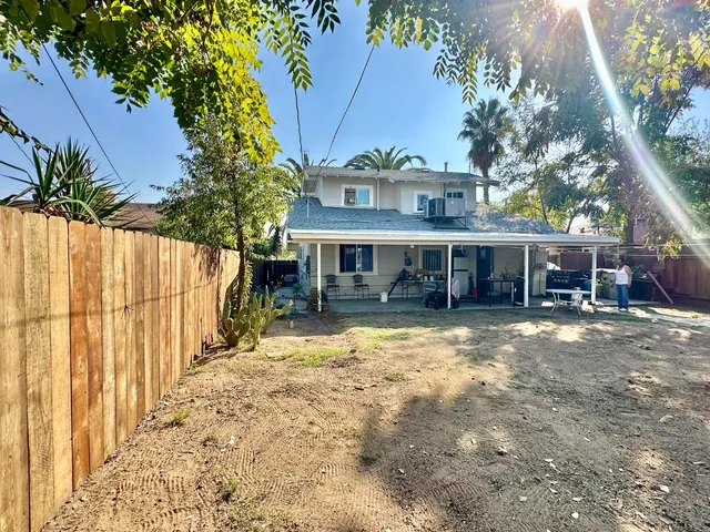 a backyard of a house with yard and outdoor seating