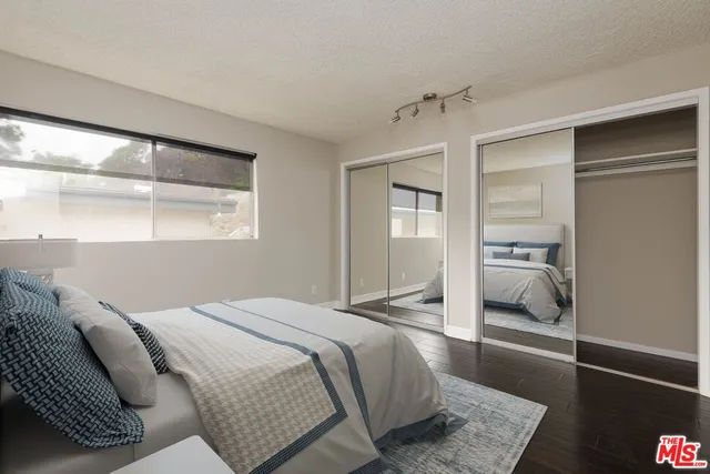 a bedroom with a large bed and a window