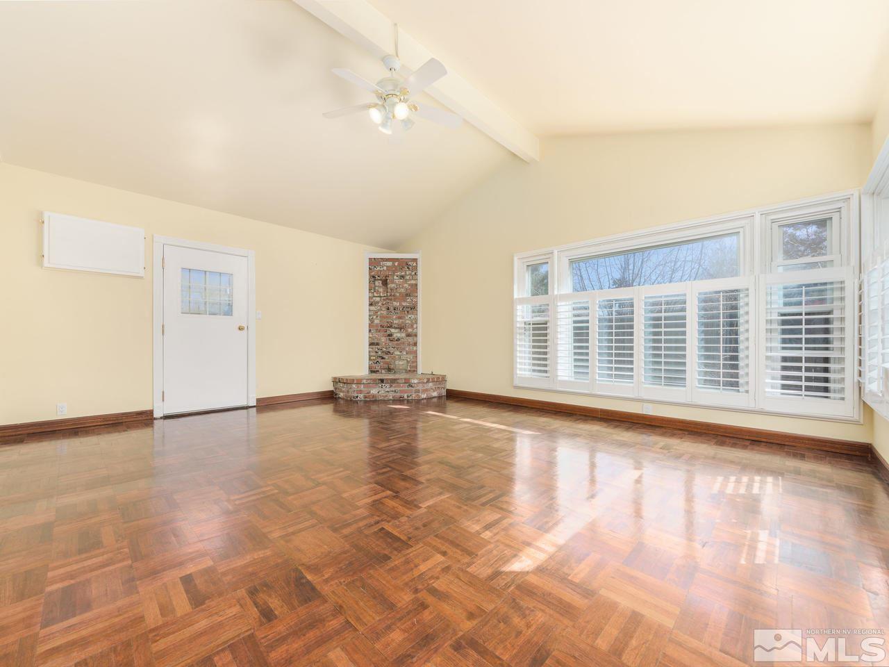 4620 Azalea Drive Reno, NV 89502 - Photo 8 of 19 an empty room with wooden floor and windows