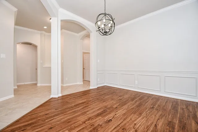 a view of an empty room with a fireplace and a window