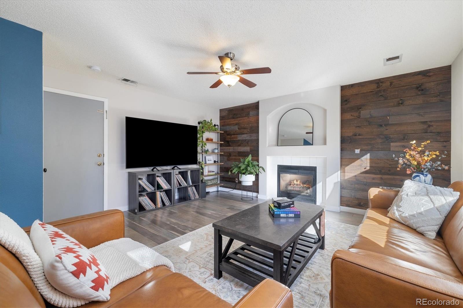 9823 South Castle Ridge Circle Highlands Ranch, CO 80129 - Photo 17 of 46 a living room with furniture a fireplace and a flat screen tv