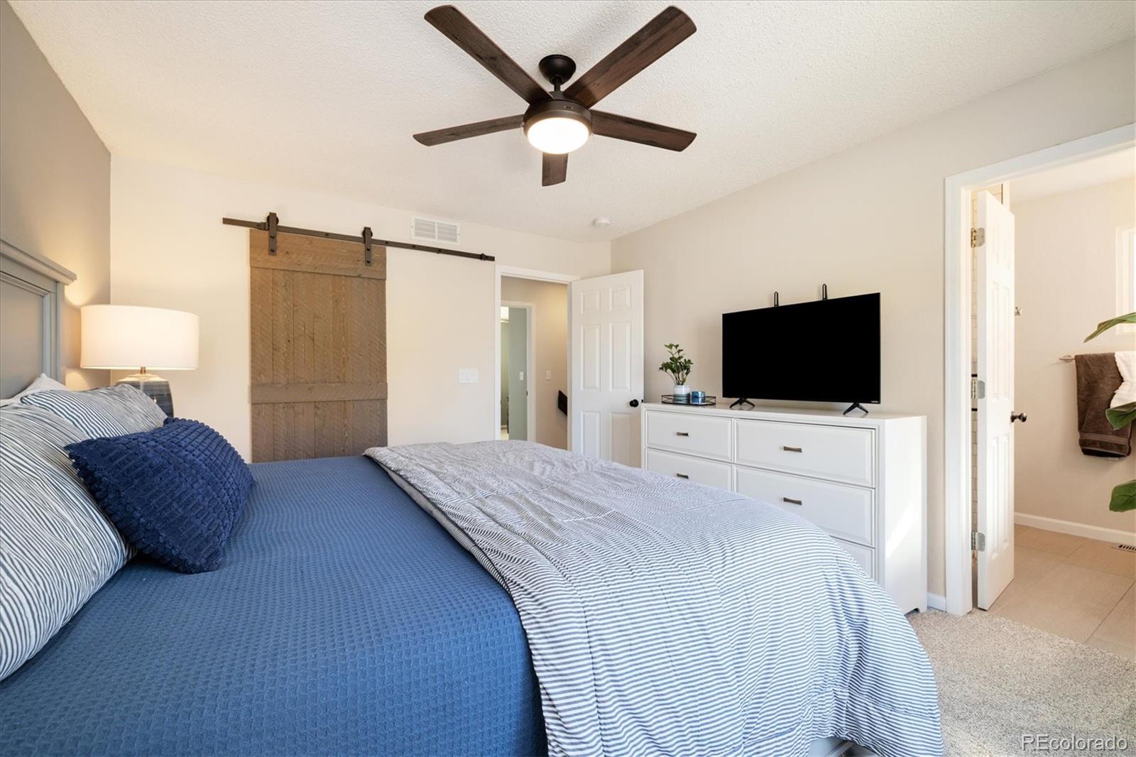 9823 South Castle Ridge Circle Highlands Ranch, CO 80129 - Photo 22 of 46 a bedroom with a bed tv and a window