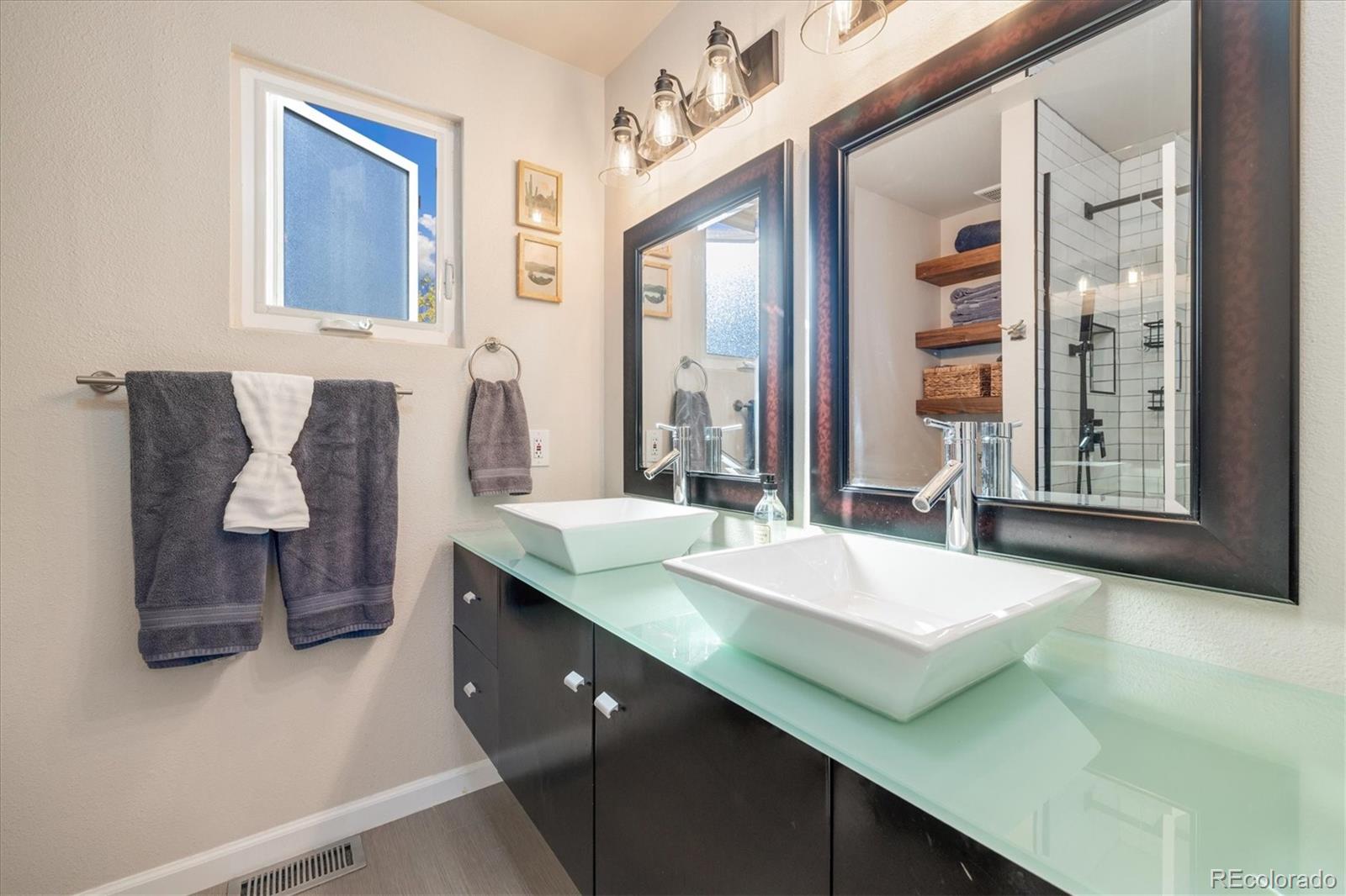 9823 South Castle Ridge Circle Highlands Ranch, CO 80129 - Photo 23 of 46 a spacious bathroom with a granite countertop sink and a mirror