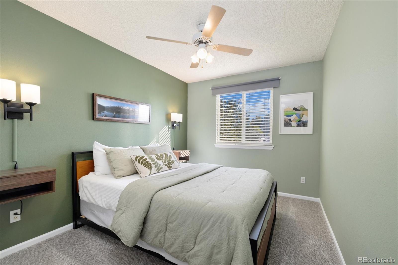 9823 South Castle Ridge Circle Highlands Ranch, CO 80129 - Photo 25 of 46 a bedroom with a large bed and a window