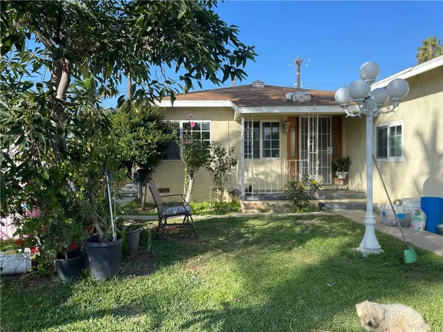 a front view of a house with a yard table and chairs