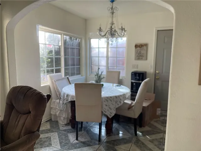 a view of a dining room with furniture and a rug
