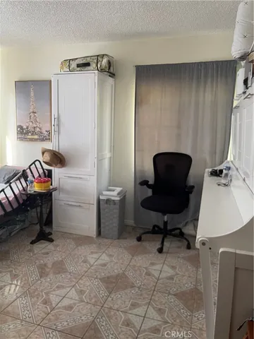 a bedroom with furniture and a large window