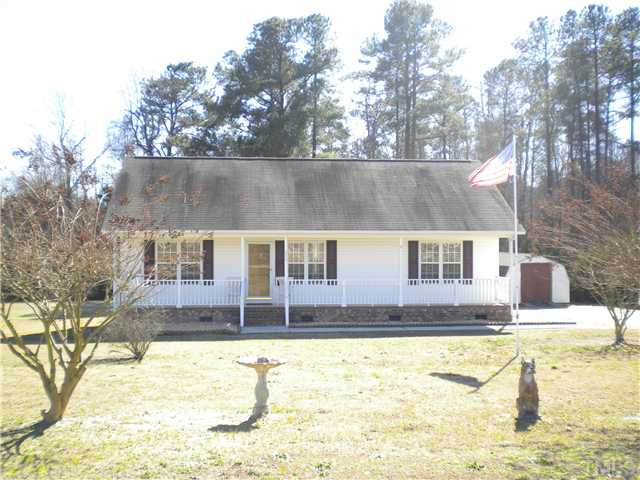 115 Forest Ridge Drive Willow Spring, NC 27592 - Photo 1 of 17 a view of a house with a yard covered with snow in the background