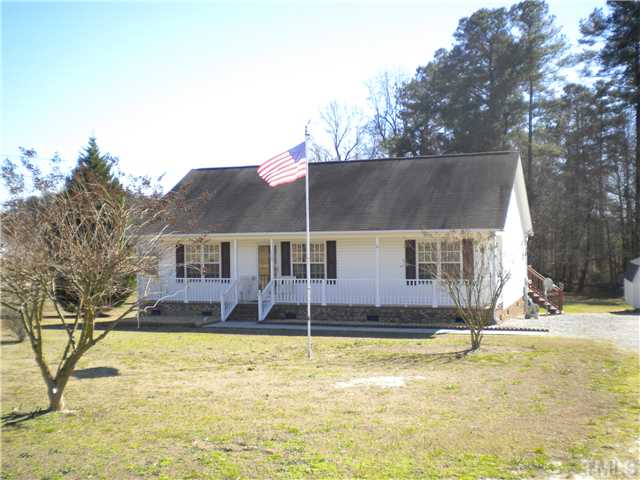 115 Forest Ridge Drive Willow Spring, NC 27592 - Photo 17 of 17 a view of a house with a yard covered with snow in the background