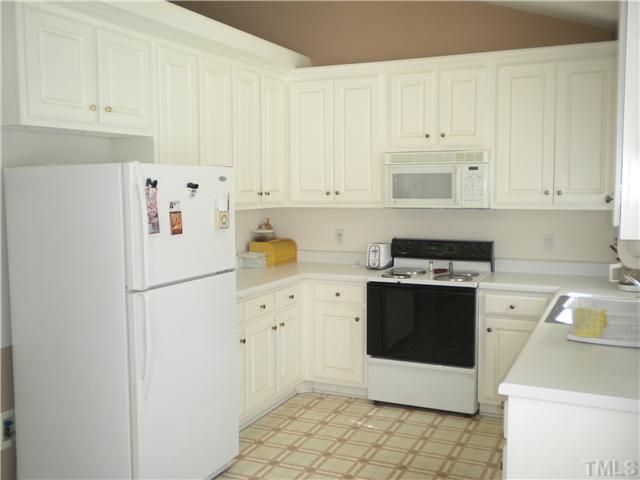 115 Forest Ridge Drive Willow Spring, NC 27592 - Photo 2 of 17 a white refrigerator freezer sitting inside of a kitchen