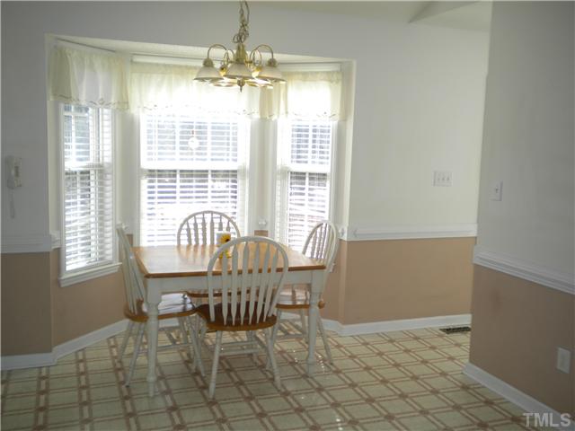 115 Forest Ridge Drive Willow Spring, NC 27592 - Photo 5 of 17 a view of a dining room with furniture and chandelier