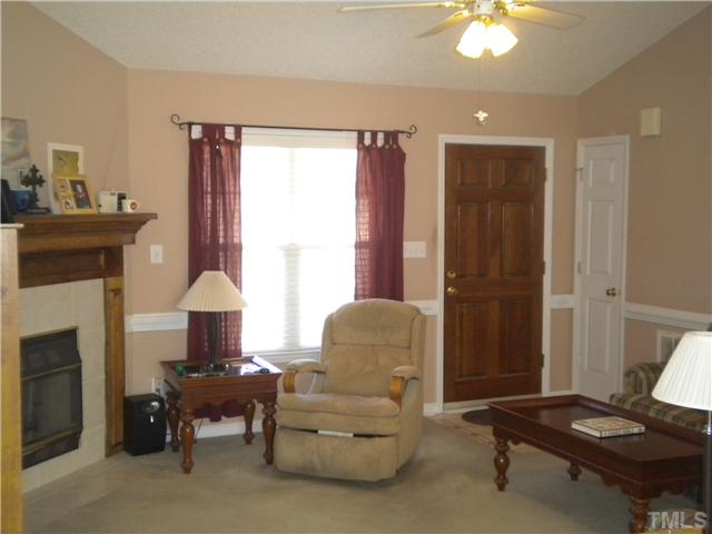 115 Forest Ridge Drive Willow Spring, NC 27592 - Photo 7 of 17 a living room with furniture and a fireplace