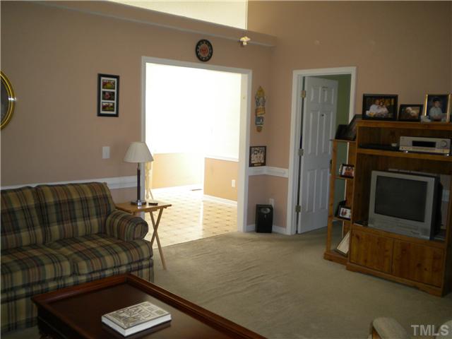 115 Forest Ridge Drive Willow Spring, NC 27592 - Photo 8 of 17 a living room with furniture and a flat screen tv