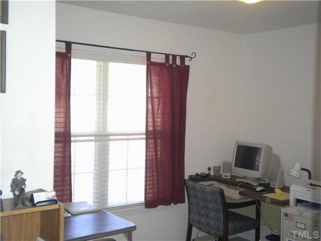 115 Forest Ridge Drive Willow Spring, NC 27592 - Photo 10 of 17 a workspace with furniture and a window