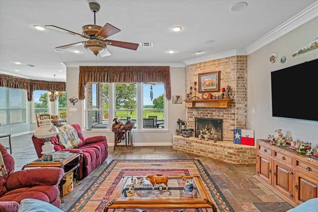 a kitchen with stainless steel appliances granite countertop a table chairs sink and stove top oven