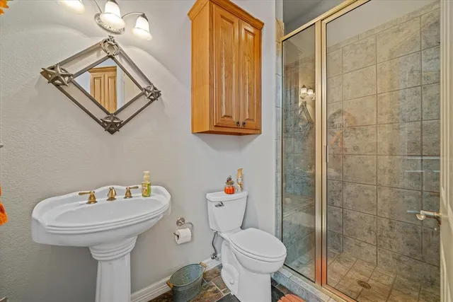 a view of a kitchen with kitchen island granite countertop a table chairs microwave and sink