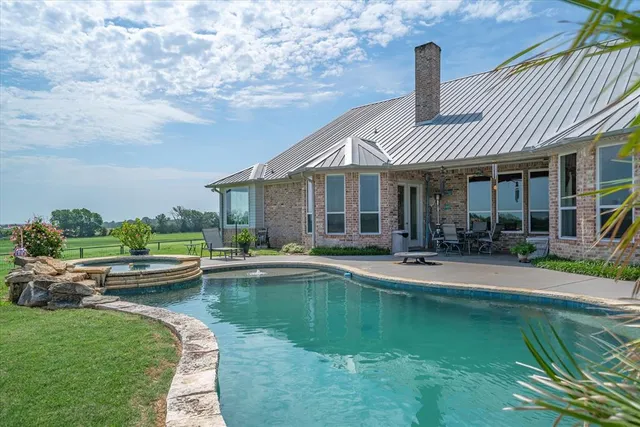 a front view of a house with a yard table and chairs
