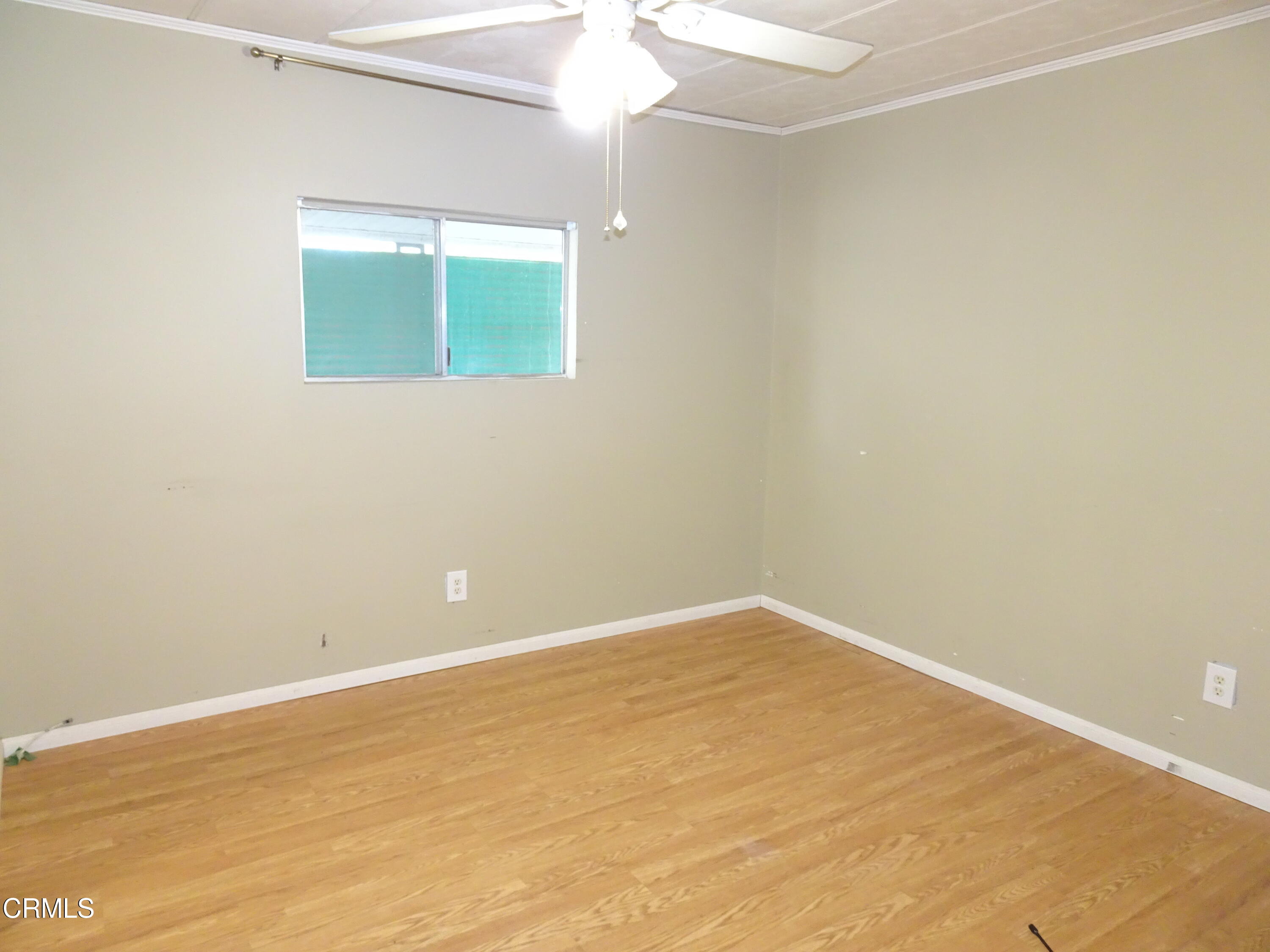 1225 South Rice Road, Unit 28 Ojai, CA 93023 - Photo 20 of 27 a view of an empty room with wooden floor and a window