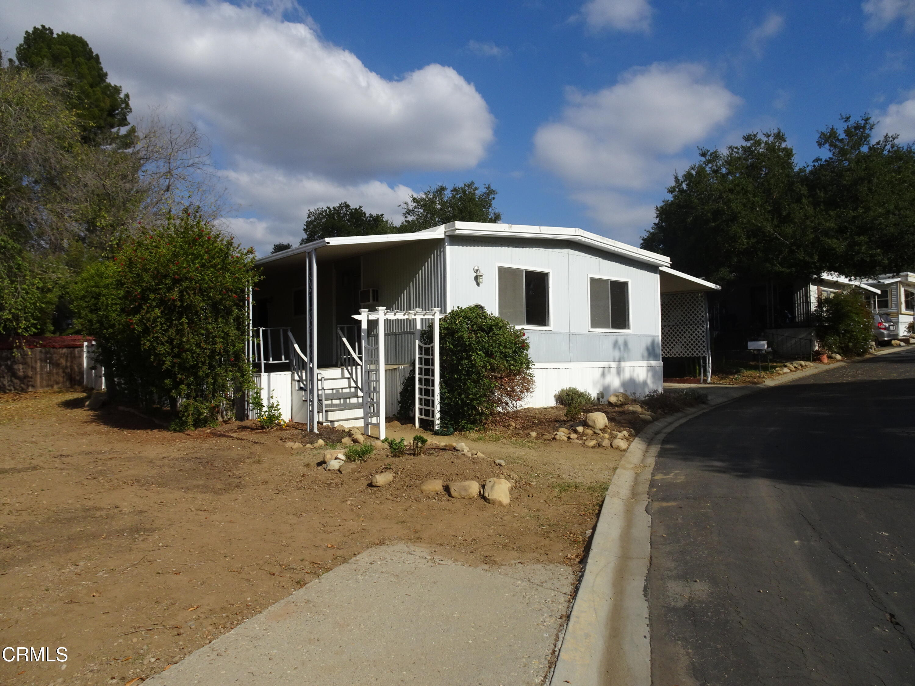 1225 South Rice Road, Unit 28 Ojai, CA 93023 - Photo 3 of 27 a front view of a house with garden