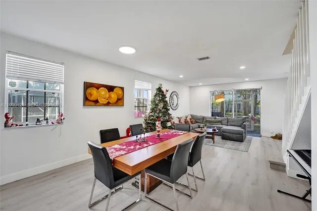 a room with furniture pool table and wooden floor